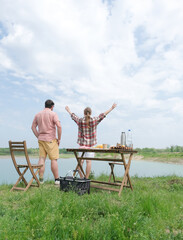 Family on picnic near the lake, looking at view