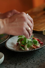 Male chef preparing salad in restaurant kitchen