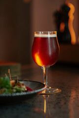 A glass of beer and a salad in a restaurant setting