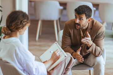Man and Woman Engaged in a Professional Counseling Meeting at an Office