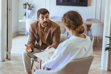 Focused Therapy Session Between Client and Therapist in a Comfortable Office Setting