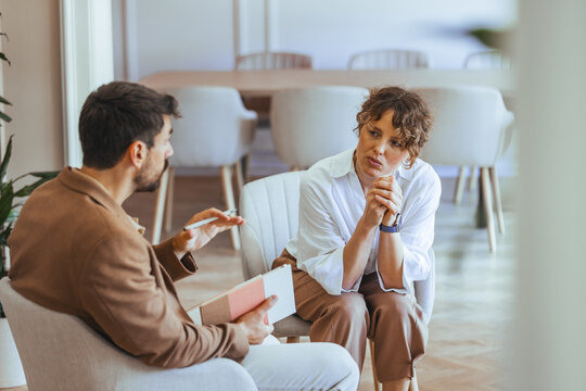 Two People Having a Conversation in a Comfortable Office Setting
