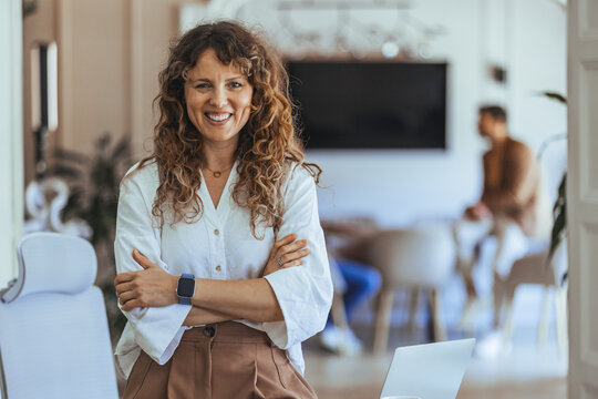 Confident Woman in Office Environment Smiling and Exuding Positive Energy