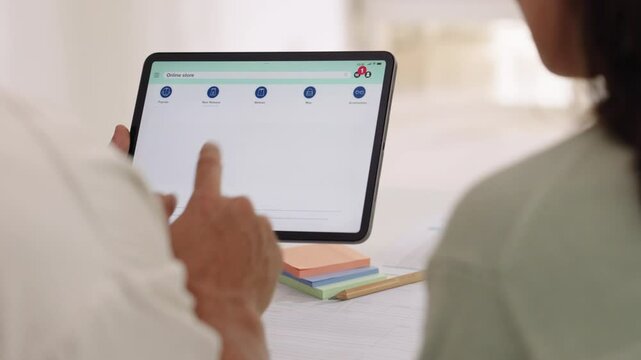 Couple using tablet and credit card to shop online through e-commerce app, making payment and browsing modern platform with promo codes and discount offers