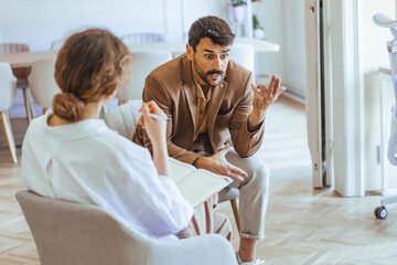 Man Expressing Frustration During Therapy Session With Professional Counselor in Office