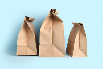 Paper bags on blue background. Food delivery service