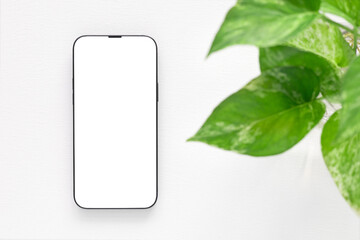 Mockup, template A minimalist flat-lay composition featuring a modern smartphone with a blank white screen over a white background. Concept online shopping, blog, logo, product, and social media..