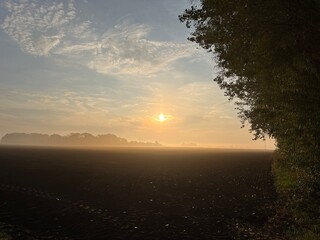 sunrise over the field a foggy morning