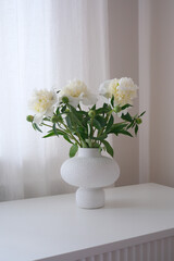 Beautiful and Elegant White Flowers Arranged Tastefully in a Modern Vase on a Minimalist Table