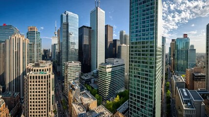 Urban Panorama: An awe-inspiring aerial view of a modern metropolis, showcasing a cluster of soaring skyscrapers piercing the vibrant blue sky.