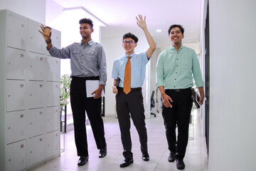 Group of Office Workers Smiling and Greeting While Walking Together