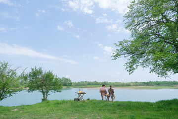 Family on picnic near the lake, looking at view