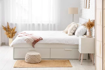 Zelfklevend Fotobehang Interior of light room with big bed, table and pampas grass in vases © Pixel-Shot
