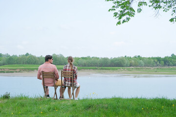Family on picnic near the lake, looking at view