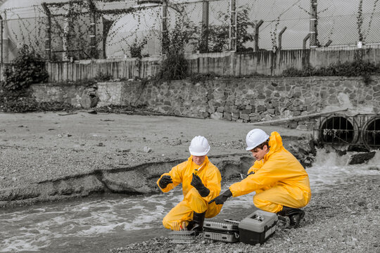 Water Pollution Control. Scientist team checking water quality from industry wastewater sewage river impact from danger toxic and chemical release