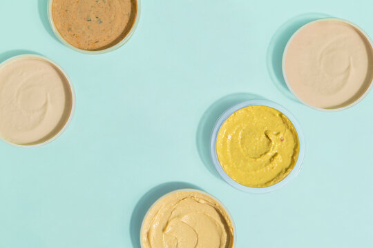 arrangement of dips and sauces on a blue background