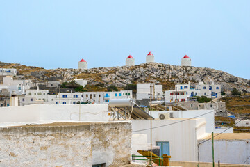 Windmills on a hill in the village of Chora on the island of Amorgos. Cyclades, Greece