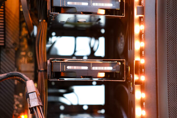 Close-up view of computer hardware components, showcasing hard drives and cables inside a modern...