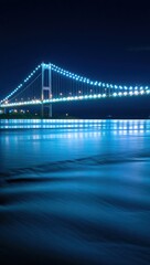 Illuminated suspension bridge night scene river reflection