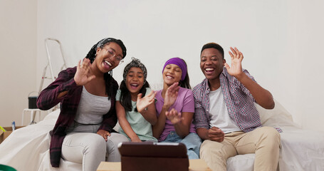 A joyful family, during a home renovation, practices recording videos for social media. The married couple and their children wave to the camera, but the tablet falls over, ruining the recording.