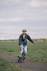 Teenager girl running with dog in a park during a cloudy day