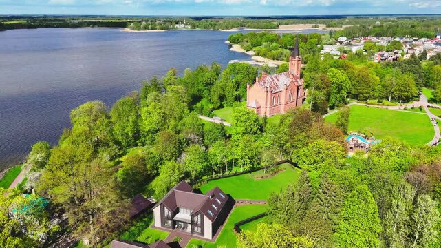 Lush Nature At The Coastal Landscape With Evangelical Reformed Church Of Lithuania. Aerial Drone Shot