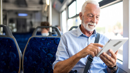 A commuter in a light blue button-up shirt sits on a bus, engaged with a tablet. Dark blue upholstered seats frame the scene, evoking themes of modern travel, technology, and productivity on the go.