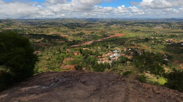 Woman tourist admires stunning panorama of Antananarivo surroundings from Royal Palace Rock in Madagascar