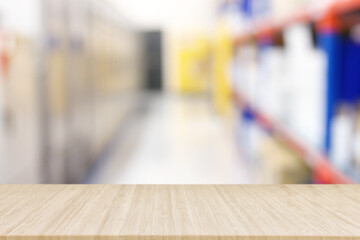 Empty table and industry warehouse background with bright lights