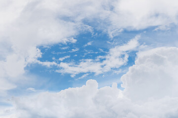 White puffy clouds on blue sky in sunny day