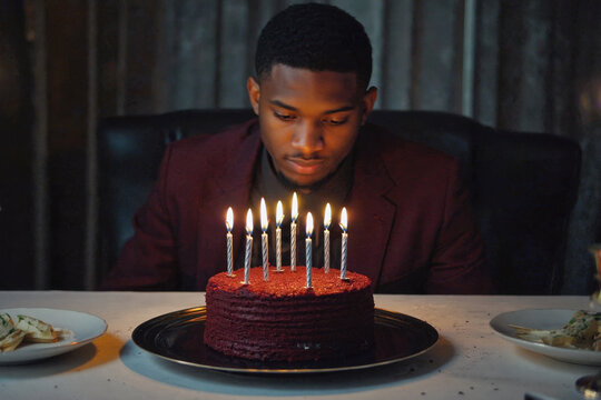 Young man blowing out candles cake, happy birthday celebration. AI Generative