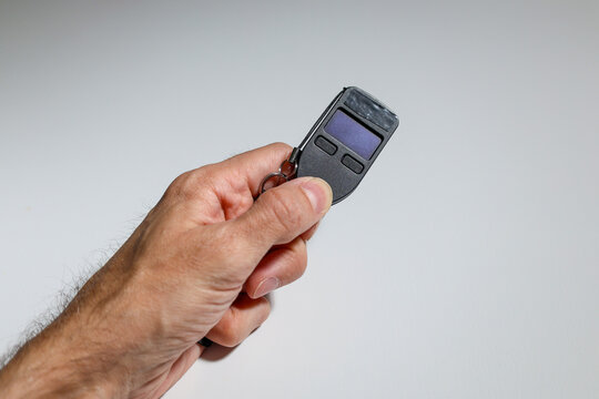 Close-up of hand holding USB-like cold wallet for cryptocurrencies