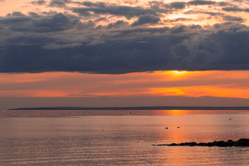 Scenic sunset at the beach.  The sky is painted in bright colors