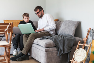 Modern digital classroom with teacher and student using laptops. Learning programming or digital...