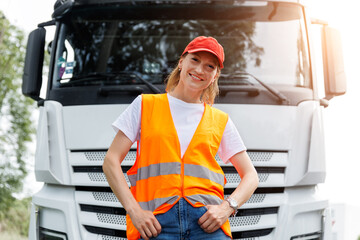 Fototapeta na wymiar Portrait young adult happy smiling woman heavy truck driver modern cargo vehicle cabin background. Female person girl professional job career working driving freight engine lorry. Logistics industry