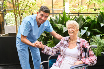 Senior caregiver assisting elderly woman in wheelchair in a garden setting
