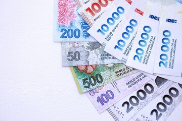 Argentine pesos money bills in big amount lies on white table close up
