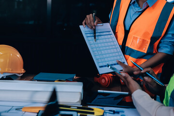 Engineers are helping to design work on blueprints and collaborate on structural analyzing of...