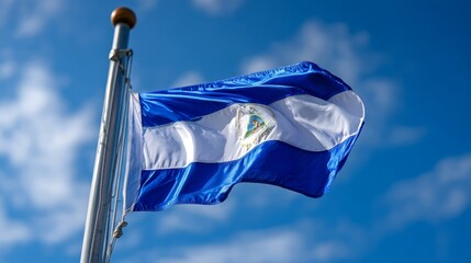 Waving flag of Nicaragua on Independence Day under a clear blue sky
