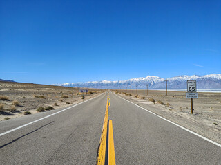 Long, straight and empty highway 190 desert road towards Olancha, Owens Lake and Sierra Nevada...