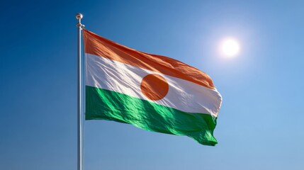 Niger's flag waving proudly during Independence Day celebration under a clear blue sky