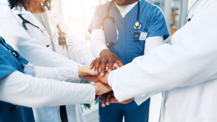 Healthcare, nurses and doctors with hands for huddle, teamwork and motivation in hospital for work....
