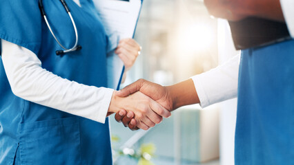 Hospital, nurses and people with handshake for welcome, teamwork or motivation in clinic for deal. Closeup, employees or partnership with shaking hands for medical, thank you or support in healthcare