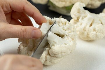 The Process of Slicing Raw Fresh Cauliflower.