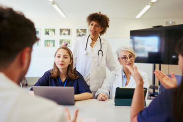 Medical team discussing patient care during hospital meeting