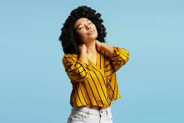 Young woman enjoying and relaxing with closed eyes, touching her neck