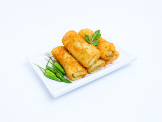 A plate of crispy golden vegetable risol served with green chili peppers and parsley garnish. isolated on white background. risol isolated