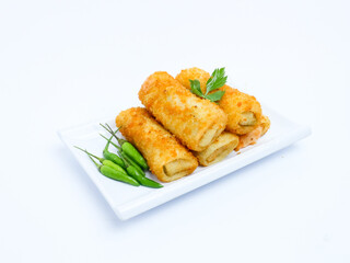 A plate of crispy golden vegetable risol served with green chili peppers and parsley garnish. isolated on white background. risol isolated