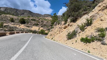 A scenic winding road gracefully surrounded by beautiful nature and lush greenery awaits