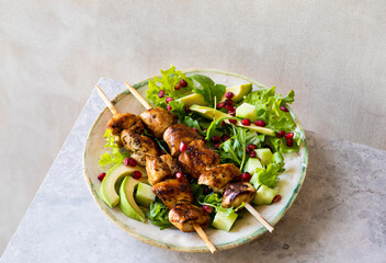 Grilled chicken skewers with salad